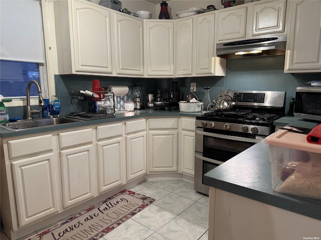 kitchen featuring white cabinets, double oven range, extractor fan, and sink