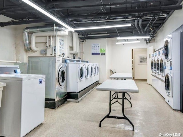 washroom with washing machine and clothes dryer and stacked washing maching and dryer