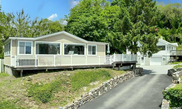 view of front of house with a wooden deck and a garage