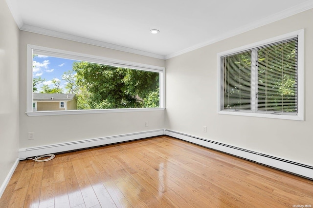 spare room featuring baseboard heating, wood-type flooring, and ornamental molding