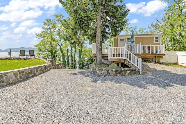 rear view of house with a deck with mountain view