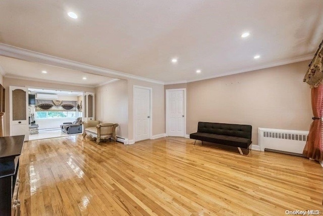 living area with radiator, a baseboard heating unit, an AC wall unit, crown molding, and light hardwood / wood-style floors