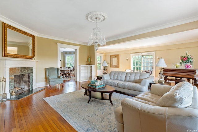 75 Oak Neck Ln, West Islip, NY 11795 - living area with healthy amount of natural light, a chandelier, a premium fireplace, crown molding, and hardwood / wood-style flooring