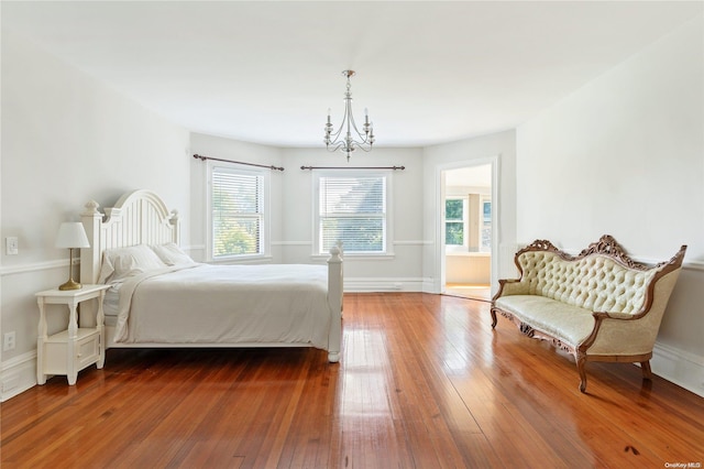 75 Oak Neck Ln, West Islip, NY 11795 - bedroom with wood-type flooring, a chandelier, and baseboards