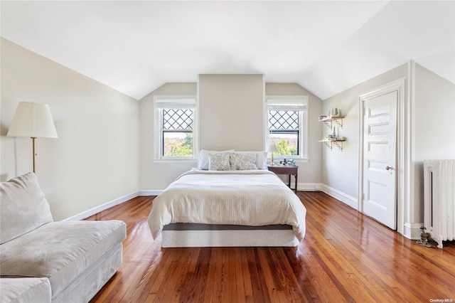 75 Oak Neck Ln, West Islip, NY 11795 - bedroom with radiator, hardwood / wood-style floors, vaulted ceiling, and baseboards