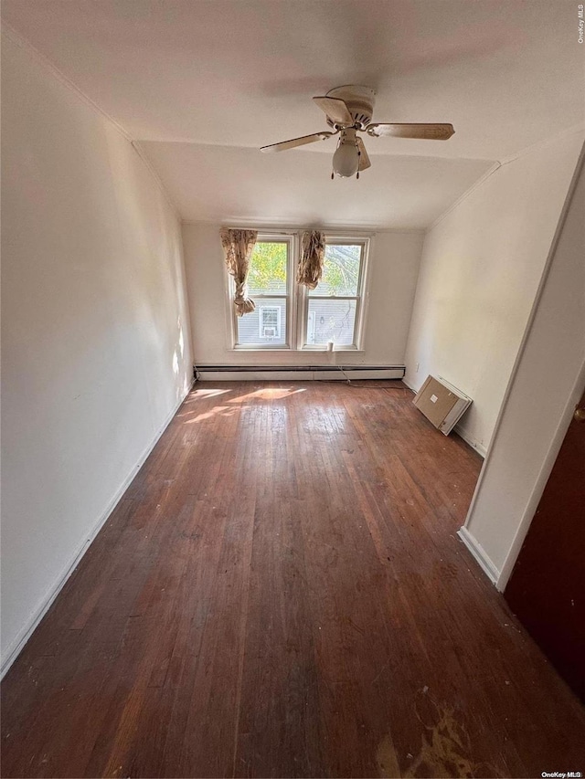 empty room featuring ceiling fan, a baseboard heating unit, dark hardwood / wood-style flooring, and vaulted ceiling