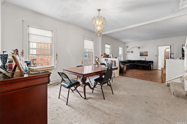 dining room with a wealth of natural light, an inviting chandelier, light hardwood / wood-style floors, and ornamental molding