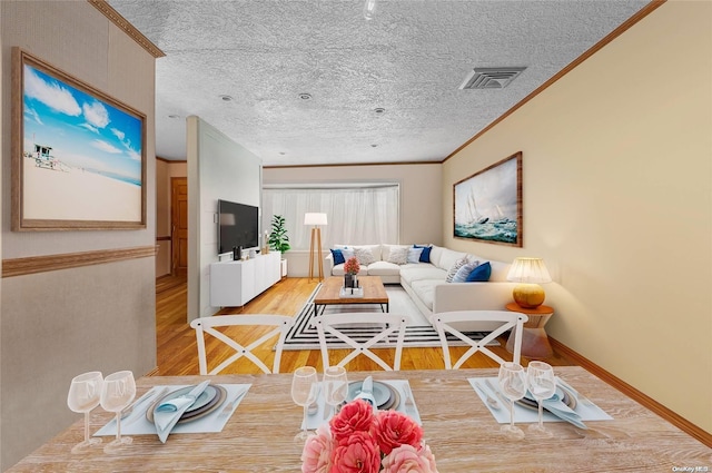 living room featuring hardwood / wood-style floors, crown molding, and a textured ceiling