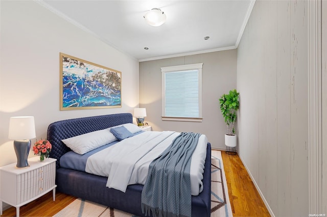 bedroom featuring hardwood / wood-style floors and ornamental molding