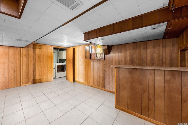 basement with washer / dryer and wood walls