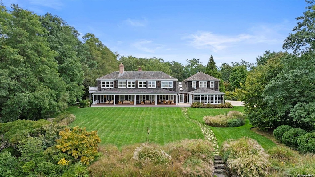 5 Casey Ln, Bridgehampton, NY 11932 - rear view of house with a lawn and a chimney