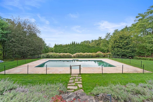 view of pool featuring a lawn