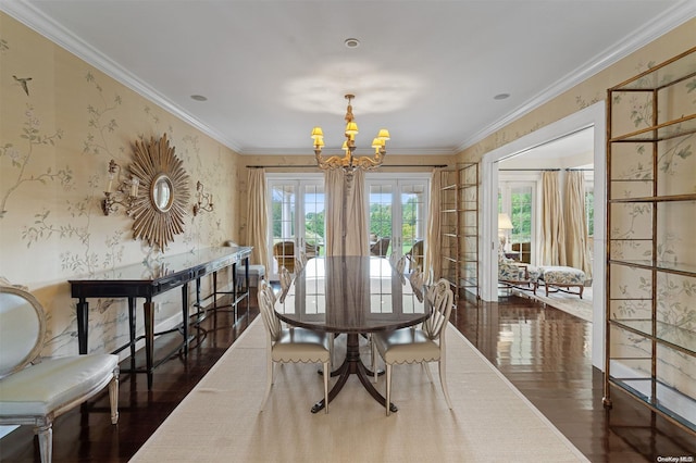 dining area with ornamental molding, dark hardwood / wood-style floors, french doors, and a notable chandelier