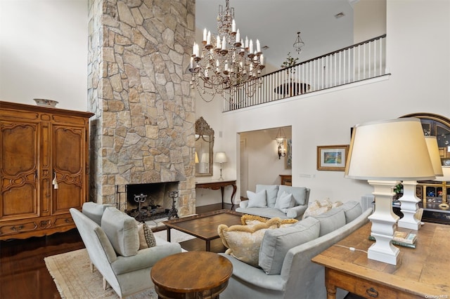 living room with a fireplace, dark hardwood / wood-style flooring, and a towering ceiling