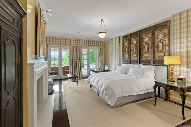 bedroom with hardwood / wood-style floors, crown molding, and french doors