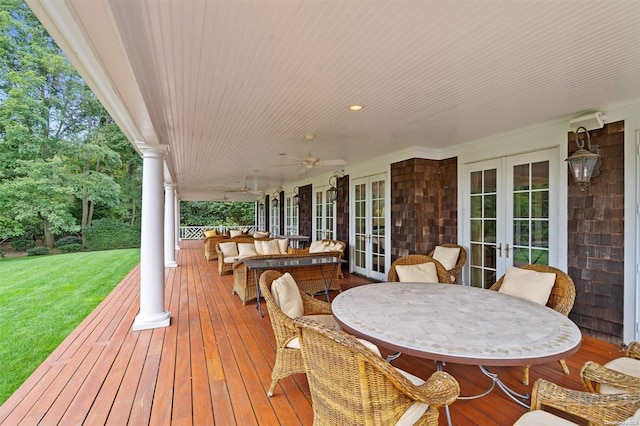 wooden deck with outdoor lounge area, french doors, a yard, and ceiling fan