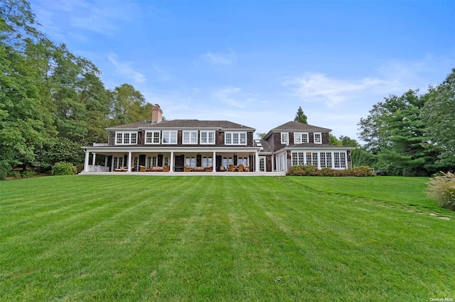 rear view of house with a lawn