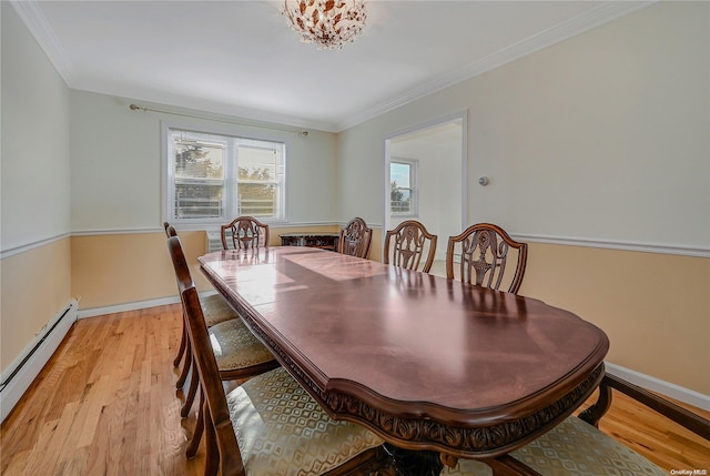 dining area featuring crown molding, a baseboard radiator, and light wood-type flooring