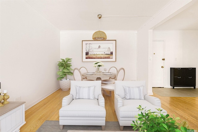 living area featuring hardwood / wood-style floors and ornamental molding