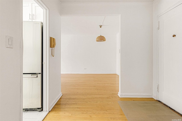 hallway with light hardwood / wood-style floors