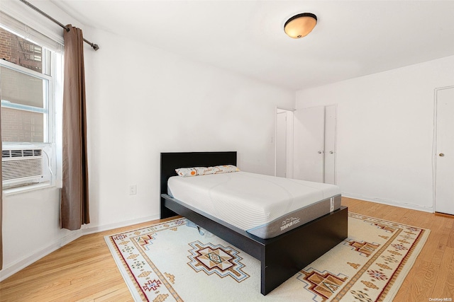 bedroom featuring hardwood / wood-style flooring and cooling unit