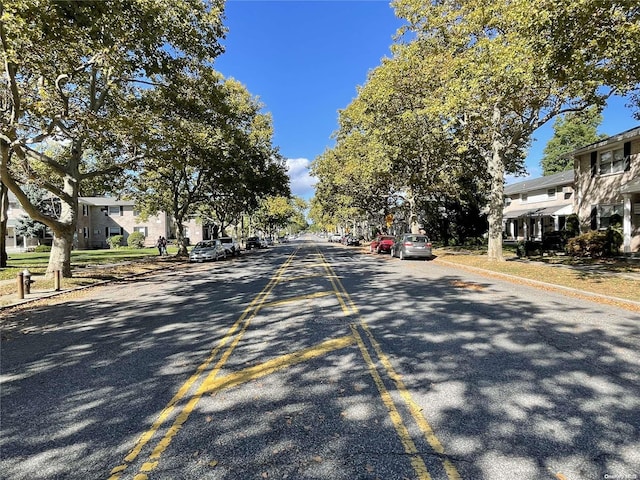 view of street featuring a residential view, curbs, and sidewalks