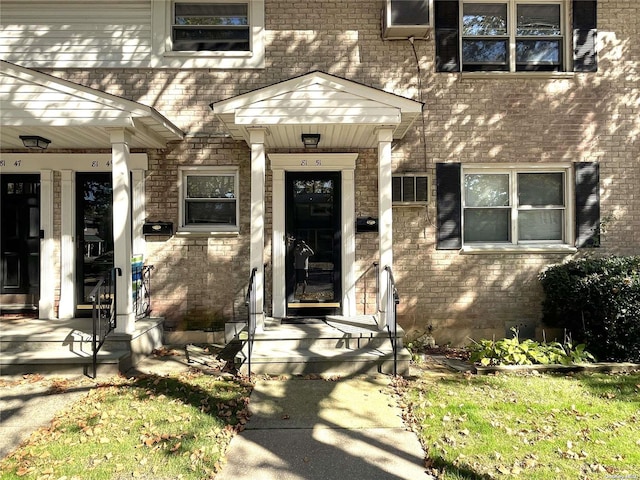 entrance to property featuring brick siding