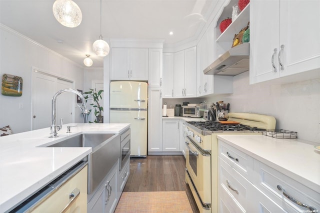 kitchen featuring stainless steel range, ventilation hood, white refrigerator, decorative light fixtures, and dark hardwood / wood-style floors