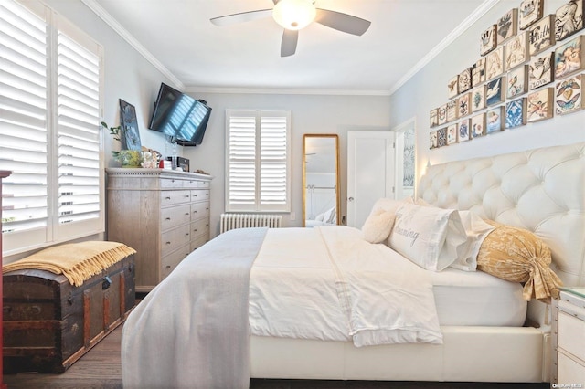 bedroom featuring ceiling fan, radiator heating unit, ornamental molding, and hardwood / wood-style flooring