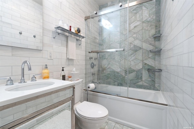 full bathroom with backsplash, sink, shower / bath combination with glass door, tile walls, and toilet