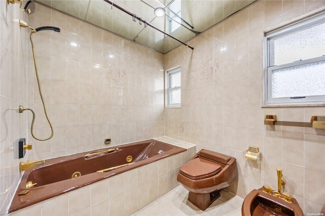 bathroom with tiled shower / bath combo, tile walls, a healthy amount of sunlight, and a bidet