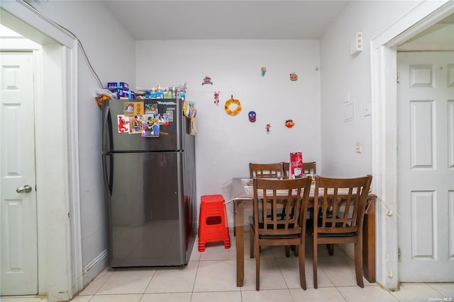 dining space featuring light tile patterned floors