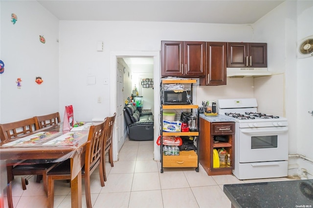 kitchen with light tile patterned floors and gas range gas stove