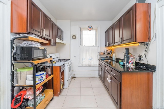 kitchen featuring light tile patterned flooring, sink, and gas range gas stove