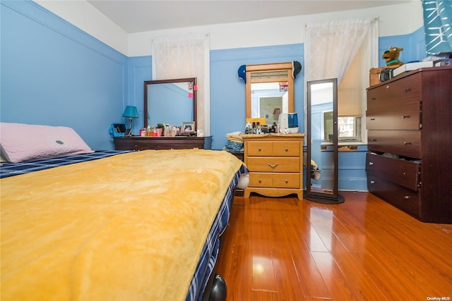 bedroom with dark hardwood / wood-style floors