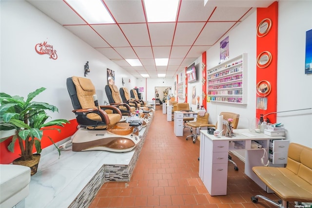 interior space with tile patterned floors and a drop ceiling