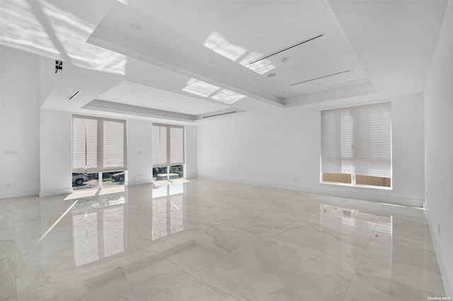 unfurnished room featuring a tray ceiling