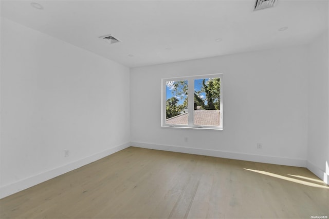 spare room featuring light hardwood / wood-style flooring