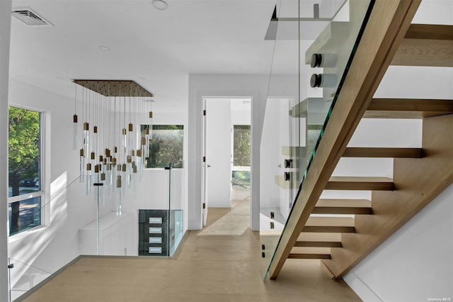 stairway with hardwood / wood-style flooring