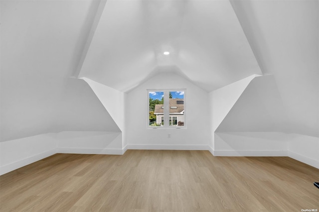 bonus room featuring light hardwood / wood-style flooring and vaulted ceiling