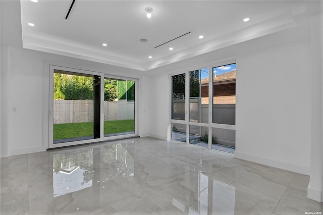 empty room with a raised ceiling