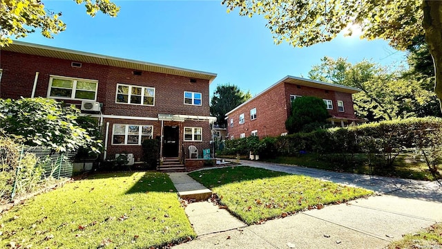 view of front of house with brick siding and a front lawn