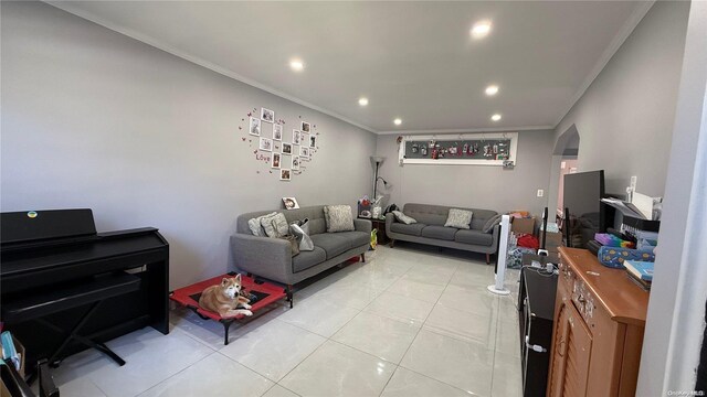 living area featuring recessed lighting, ornamental molding, arched walkways, and light tile patterned flooring