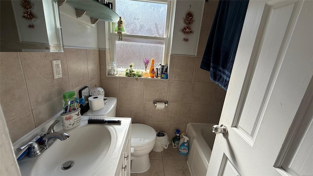 bathroom featuring toilet, a bathtub, tile walls, and tile patterned floors