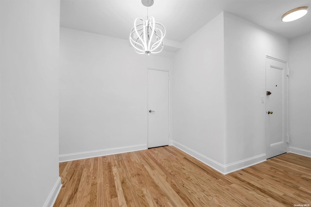 interior space with hardwood / wood-style flooring and an inviting chandelier