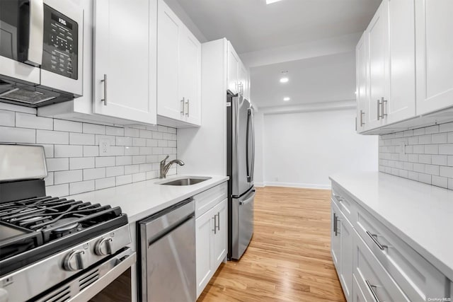 kitchen featuring sink, white cabinets, and stainless steel appliances