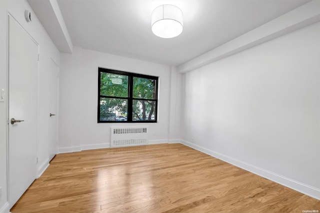 interior space featuring radiator and light hardwood / wood-style flooring