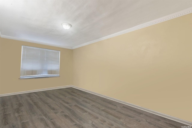 spare room with ornamental molding and dark wood-type flooring