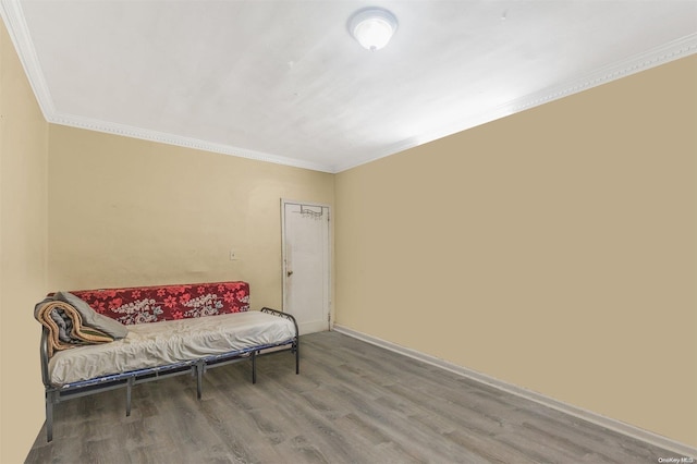 living area with hardwood / wood-style floors and crown molding