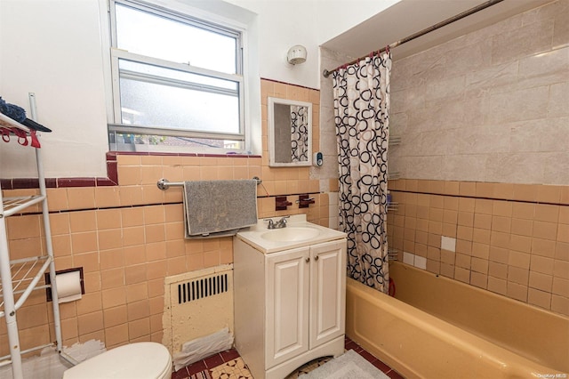 full bathroom with vanity, radiator, toilet, tile walls, and shower / tub combo with curtain